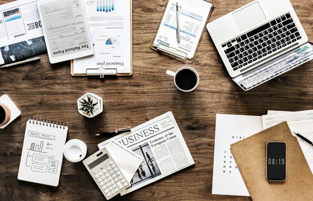 Desktop covered with financial statements and tax forms.